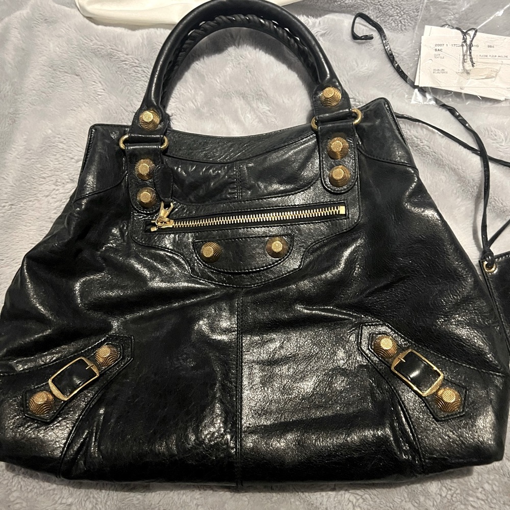 Balenciaga black handbag gold trim. Never used. Tags inside.